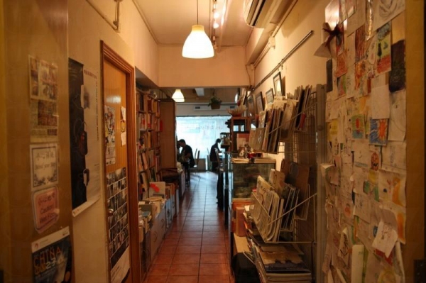 Les Artistes Café 一入門口就是放滿了書與雜誌的書架，形成簡書店的一角。