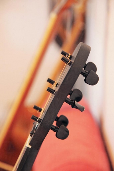 有別於一般結他以齒輪拉緊弦線，新設計保留類似小提琴靠拉力固定弦綫的傳統結構。
